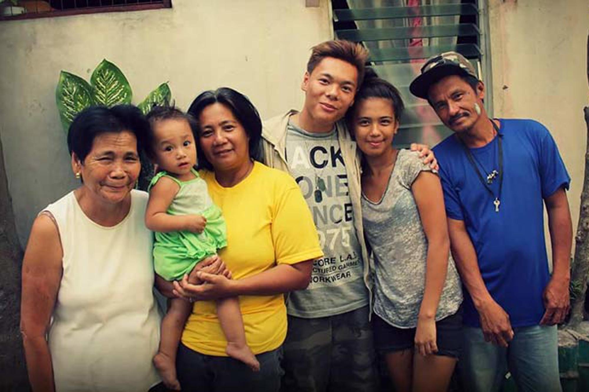 John tillsammans med sin biologiska familj i Filippinerna. Från vänster: Hans mormor, systerdotter, mamma, John själv, hans syster och pappa.